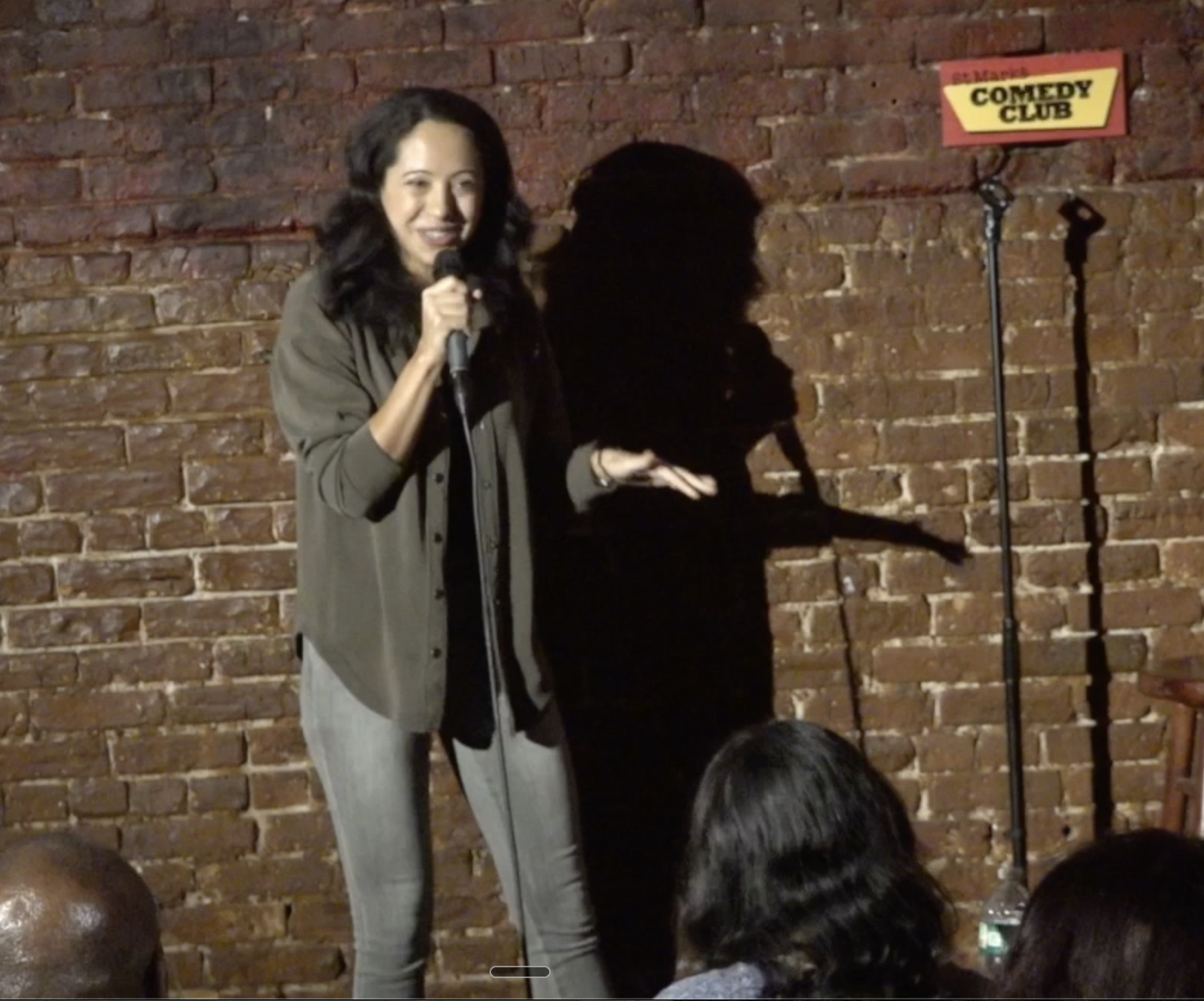 Dr. Sarah Kay performing stand-up on stage