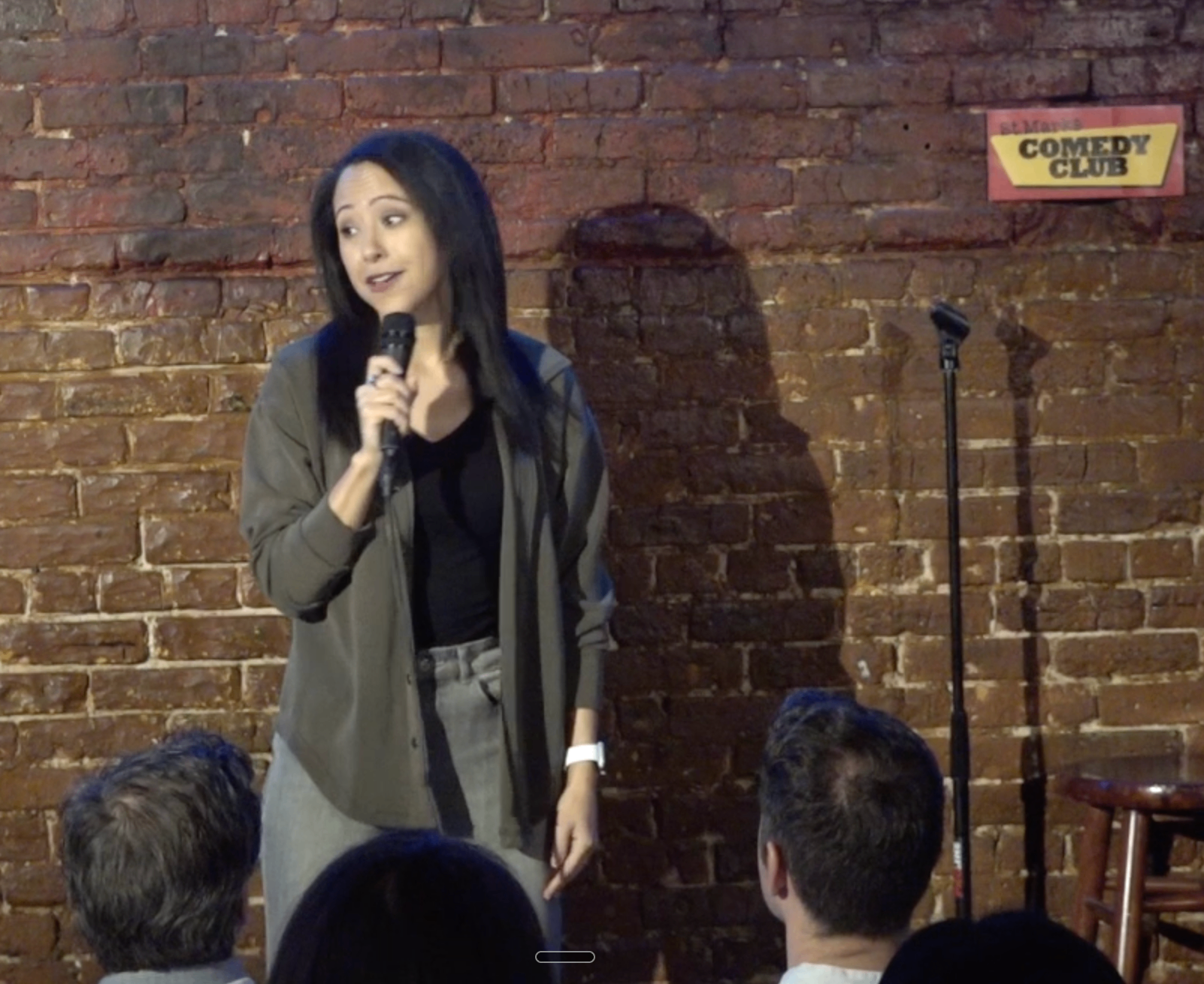 Dr. Sarah Kay performing stand-up on stage